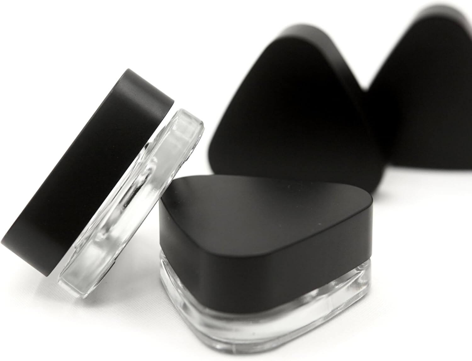 Child-resistant 9ml triangle glass jars with black lids, ideal for concentrates and premium small products.