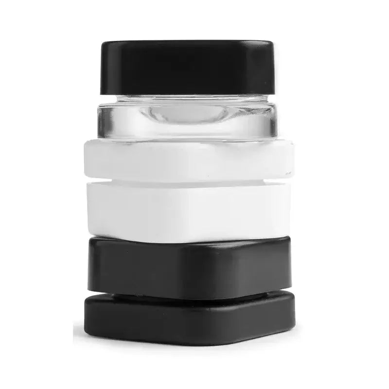 Stack of 9ml square glass concentrate jars in black and white with child-resistant lids, premium storage solution.