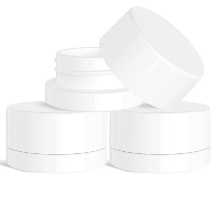 9 ML round white glass jars stacked, ideal for cannabis concentrates and skincare products.