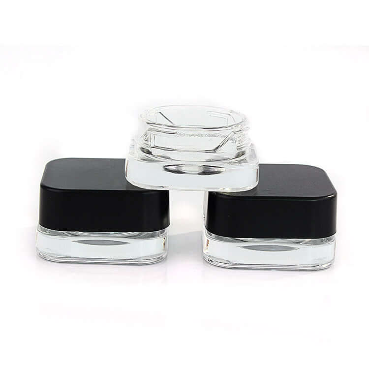5 ML square clear glass jars with black lids, perfect for skincare, oils, and sample packaging.