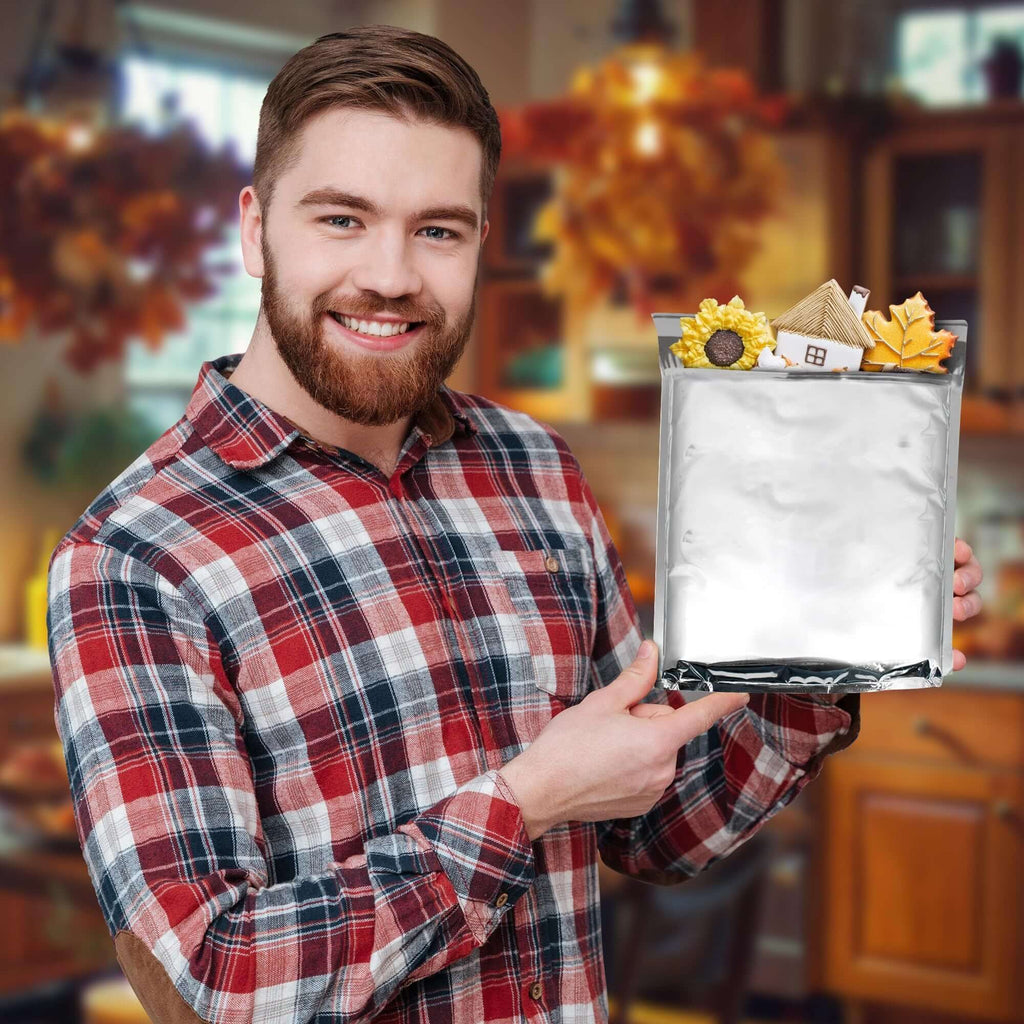 Man holding an insulated mailer bag filled with decorative items in a cozy kitchen setting.