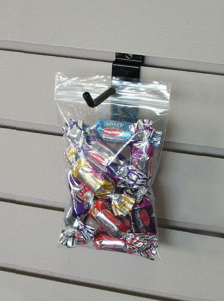 Zipper bag filled with assorted candies, hanging securely with a hook on display.