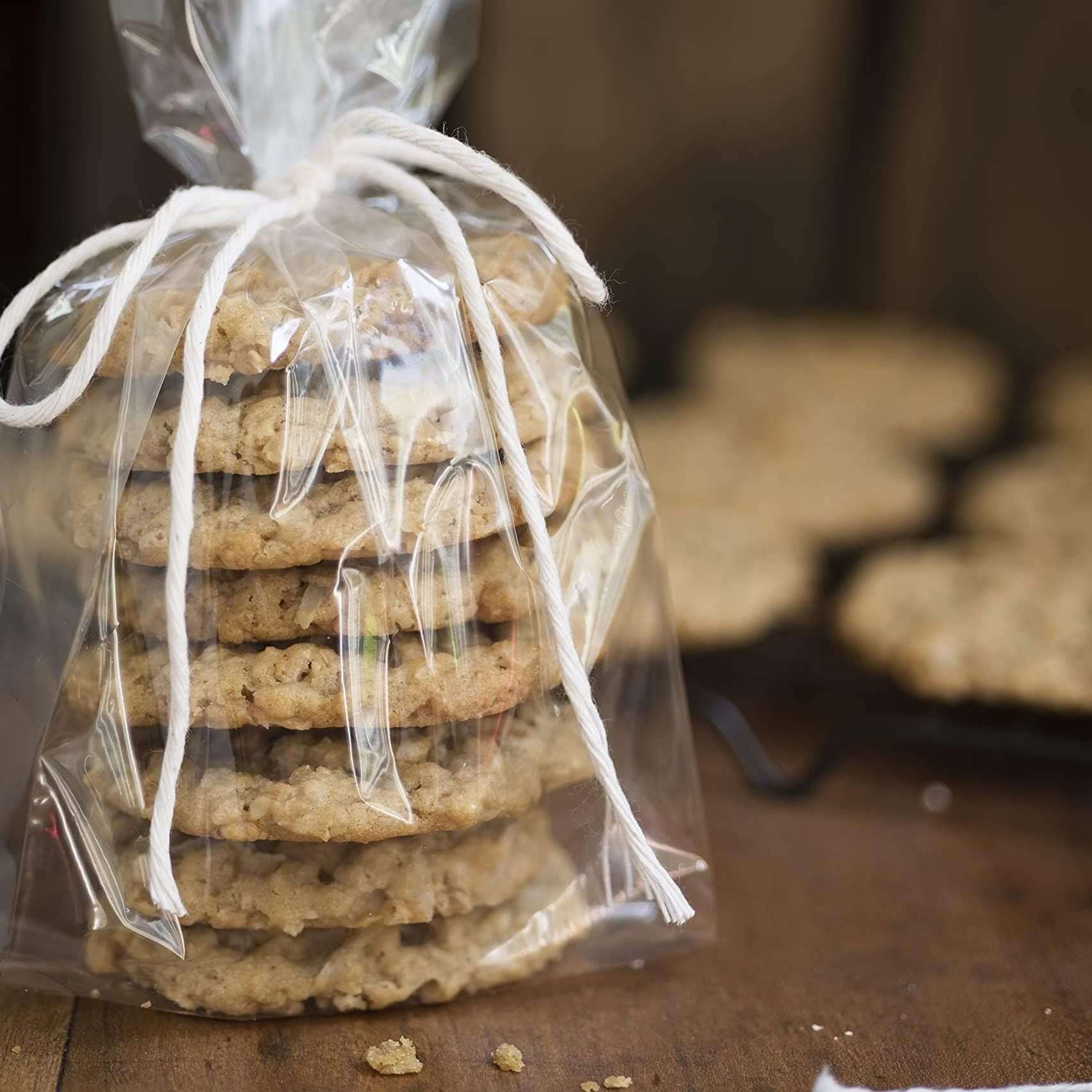 Clear gusseted poly bag filled with homemade cookies, tied with twine, showcasing baked treats for favors.