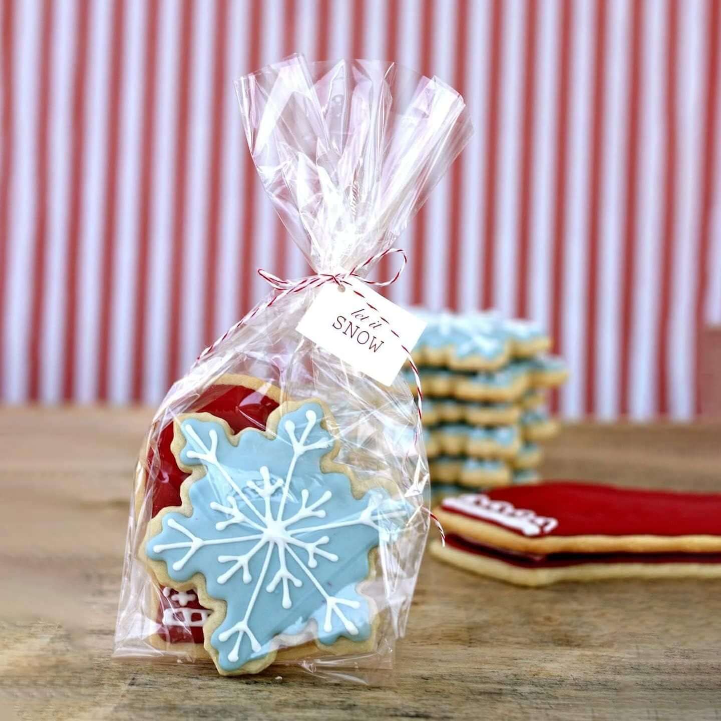 Clear gusseted poly bag containing decorated cookies with a snowflake and holiday theme, ideal for gift favors.