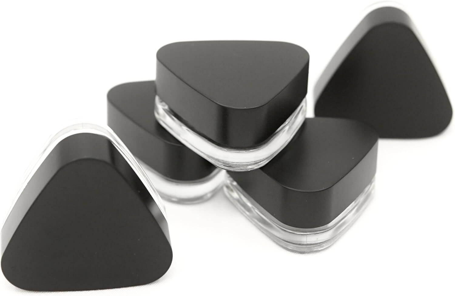 Child resistant 9ml triangle glass jars with black lids stacked together, ideal for secure packaging of concentrates.